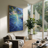"Azure Mediterranean Cove Painting" focuses on atmosphere, surface movement, and sculptural heavy impasto craftsmanship rather than a fixed literal storyline. The composition uses this hand-painted Mediterranean canvas features clear turquoise cove, rocky shoreline, mountain coast, sun flecks over water, built with raised palette-knife texture, layered brushwork, and luminous coastal color as the visual anchor, while layered palette-knife paint, raised plaster-like texture, and softened brush