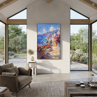 "Coastal Mountain Village Painting" focuses on atmosphere, surface movement, and sculptural heavy impasto craftsmanship rather than a fixed literal storyline. The composition uses this hand-painted Mediterranean canvas features steep coastal cliffs, hillside village, deep blue water, floral foreground, textured sky, built with raised palette-knife texture, layered brushwork, and luminous coastal color as the visual anchor, while layered palette-knife paint, raised plaster-like texture, and