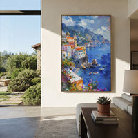 "Pink Bloom Coastal Path Painting" focuses on atmosphere, surface movement, and sculptural heavy impasto craftsmanship rather than a fixed literal storyline. The composition uses this hand-painted Mediterranean canvas features whitewashed stone lane, cascading pink bougainvillea, blue sea opening, sunlit village walls, built with raised palette-knife texture, layered brushwork, and luminous coastal color as the visual anchor, while layered palette-knife paint, raised plaster-like texture, and