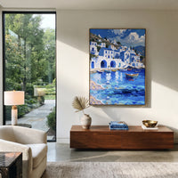 "Colorful Harbor Village Study Painting" focuses on atmosphere, surface movement, and sculptural heavy impasto craftsmanship rather than a fixed literal storyline. The composition uses this hand-painted Mediterranean canvas features colorful waterfront houses, moored boats, shimmering blue harbor reflections, pastel sky, built with raised palette-knife texture, layered brushwork, and luminous coastal color as the visual anchor, while layered palette-knife paint, raised plaster-like texture, and