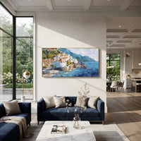 "Bright Coastal Town Painting" focuses on atmosphere, surface movement, and sculptural heavy impasto craftsmanship rather than a fixed literal storyline. The composition uses this hand-painted Mediterranean canvas features stacked pastel buildings on seaside cliffs, boats below, bright impasto coastal color, built with raised palette-knife texture, layered brushwork, and luminous coastal color as the visual anchor, while layered palette-knife paint, raised plaster-like texture, and softened