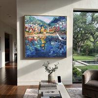 "Harbor Village Reflections Coastal with Sailboats Painting" focuses on atmosphere, surface movement, and sculptural heavy impasto craftsmanship rather than a fixed literal storyline. The composition uses this hand-painted Mediterranean canvas features colorful waterfront houses, moored boats, shimmering blue harbor reflections, pastel sky, built with raised palette-knife texture, layered brushwork, and luminous coastal color as the visual anchor, while layered palette-knife paint, raised