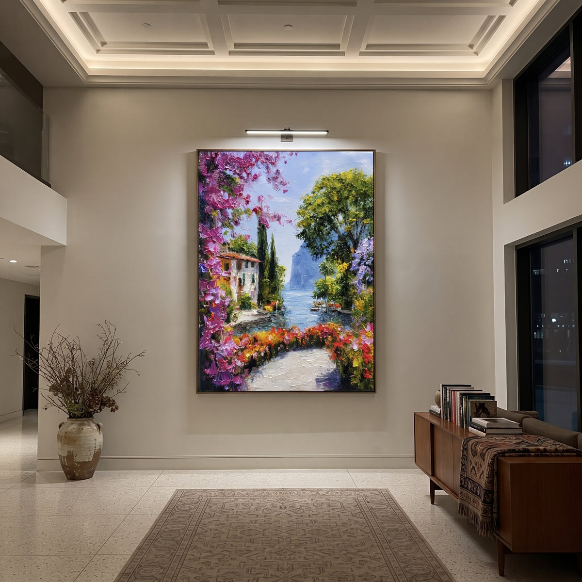 "Mediterranean Floral Passage Painting" focuses on atmosphere, surface movement, and sculptural heavy impasto craftsmanship rather than a fixed literal storyline. The composition uses this hand-painted Mediterranean canvas features whitewashed stone lane, cascading pink bougainvillea, blue sea opening, sunlit village walls, built with raised palette-knife texture, layered brushwork, and luminous coastal color as the visual anchor, while layered palette-knife paint, raised plaster-like texture