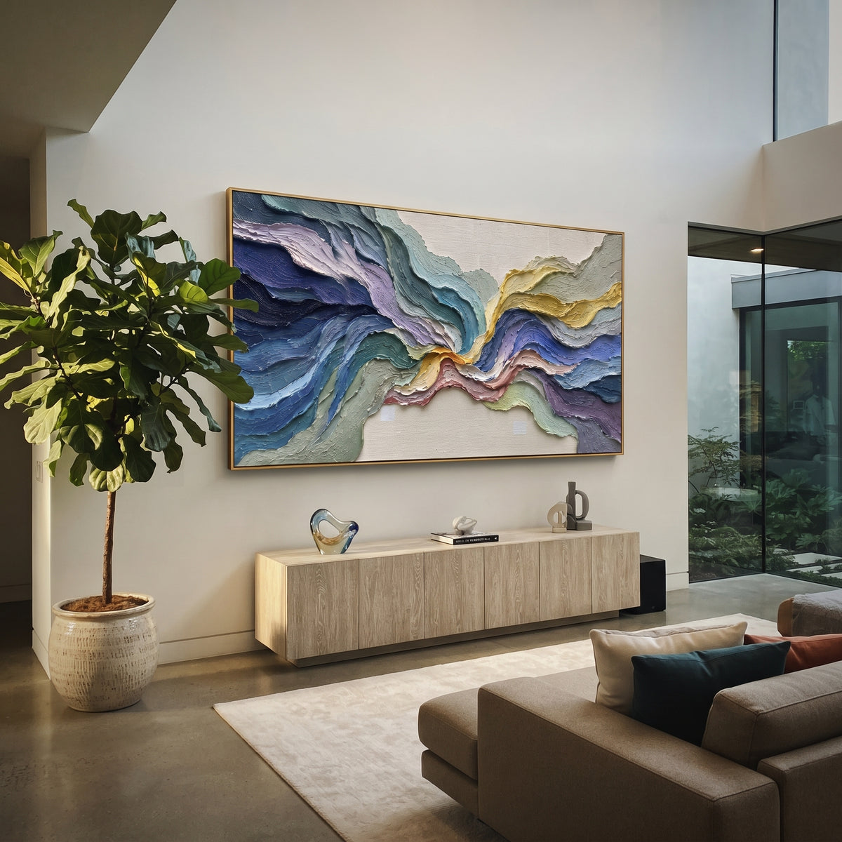 This colorful flowing terrain relief painting is built from thick curving bands of blue, teal, lavender, sage, and golden yellow. The panoramic composition feels like abstract topography, giving the wall layered motion and bright handmade texture.