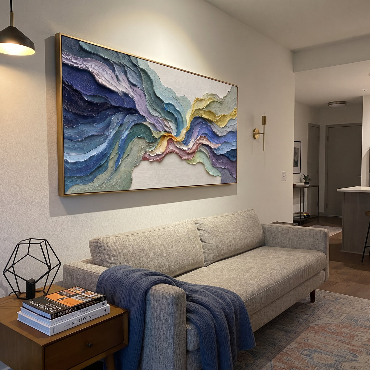 This colorful flowing terrain relief painting is built from thick curving bands of blue, teal, lavender, sage, and golden yellow. The panoramic composition feels like abstract topography, giving the wall layered motion and bright handmade texture.