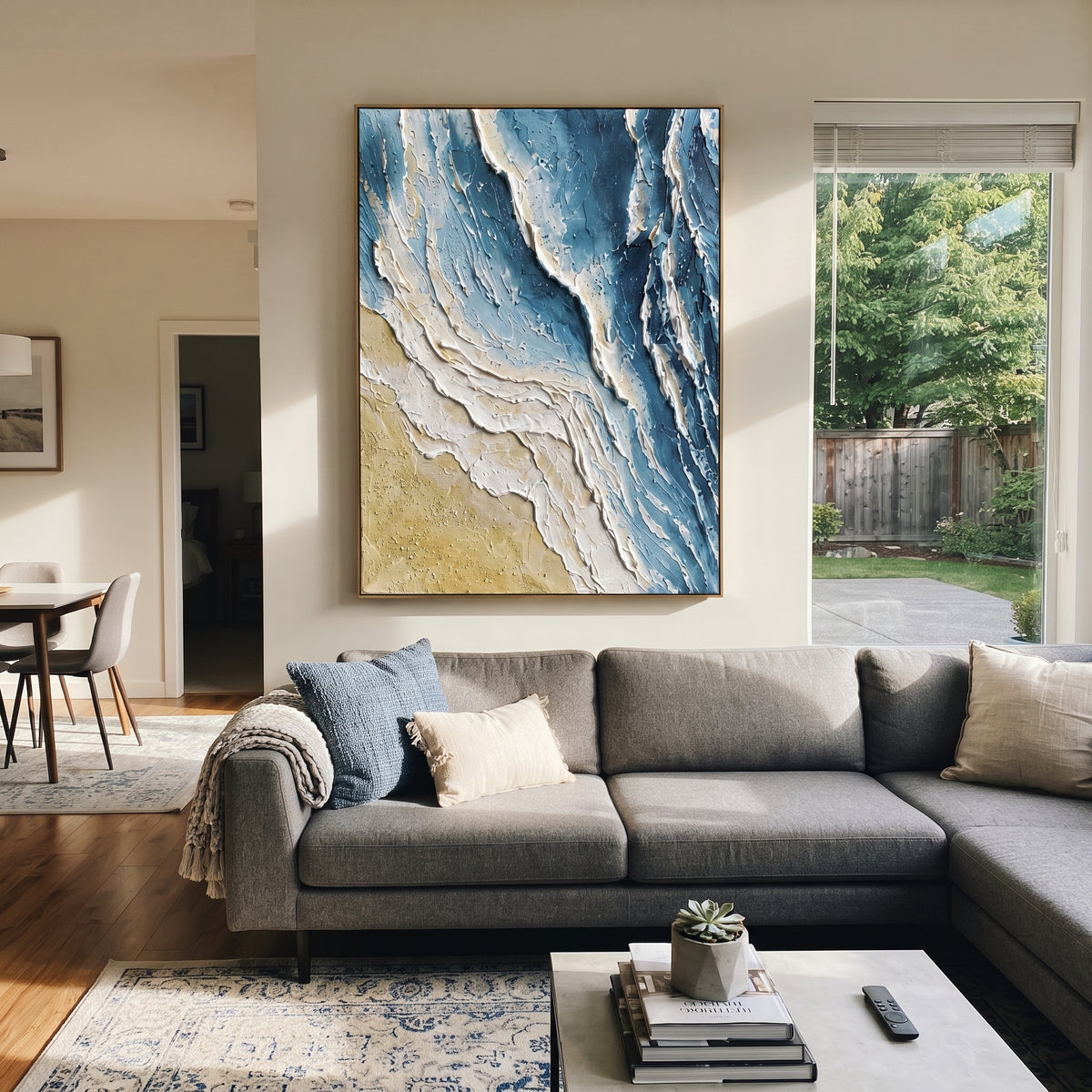 Blue Shoreline Plaster Relief focuses on this hand-painted vertical textured canvas features blue and white shoreline forms, sandy beige texture, and layered plaster strokes that suggest surf meeting the beach from an abstract aerial view. The composition is described from the actual main image, so the visible subject, color balance, spacing, and surface movement stay specific to this product instead of reading like a batch title. Raised palette-knife layers, sculpted impasto ridges, softened