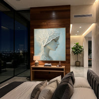 White Branch Woman Relief focuses on this hand-painted textured canvas features a serene female profile, raised white branching tree forms, pale blue ground, soft facial shading, and delicate botanical relief. The composition is described from the actual main image, so the visible subject, color balance, spacing, and surface movement stay specific to this product instead of reading like a batch title. Raised palette-knife layers, sculpted impasto ridges, softened brush transitions, and tactile