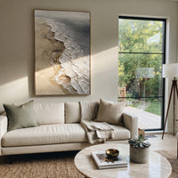 Neutral Foamy Shoreline Relief focuses on this hand-painted textured canvas features a vertical aerial shore with sandy beige texture, raised white foam edges, and grey water tones. The title and description are matched to the actual main image, so the visible subject, color balance, spacing, and surface movement stay specific to this product instead of using a repeated batch phrase. Raised palette-knife layers, sculpted impasto ridges, softened brush transitions, and tactile handmade texture