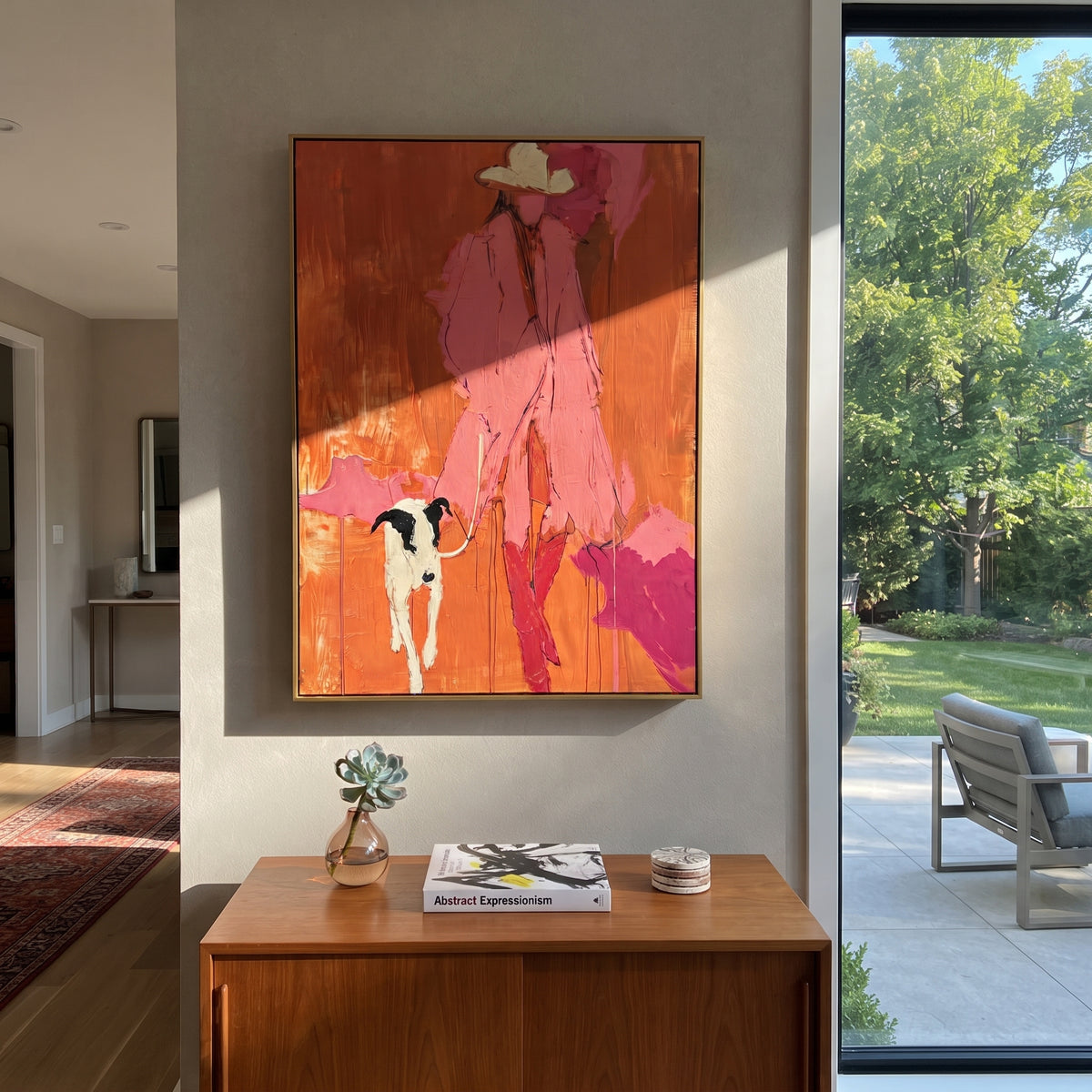 Pink Figure With White Dog focuses on this hand-painted textured canvas features bright pink figure and white dog standing against a red orange abstract background. The composition is described from the actual main image, so the visible subject, color balance, spacing, and surface movement stay specific to this product instead of reading like a batch title. Raised palette-knife layers, sculpted impasto ridges, softened brush transitions, and tactile handmade texture give the canvas dimensional