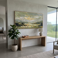 Sage Valley Field Landscape focuses on soft valley fields and cloudy sky painted in muted sage and cream tones, using the sage green family as the main atmosphere while keeping the subject and composition specific to the actual main image. The visible details are described from the artwork itself: the placement of the main forms, the surrounding negative space, the relationship between pale highlights and deeper green or dark accents, and the direction of the brushwork across the surface. Raised