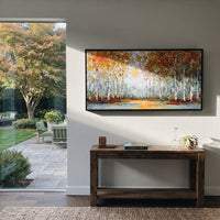 ARTWORK DETAILS Autumn Birch Lake Glow Painting is built from the actual artwork image: low lake reflection and pale sun behind a birch shoreline. The composition uses raised texture to separate tree trunks, leaf masses, ground movement, and soft background atmosphere, so the surface reads with real hand-painted depth from different viewing angles. The color direction is yellow, white, blue, chosen to keep the autumn mood warm while still leaving enough pale air and cool contrast for modern