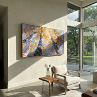 ARTWORK DETAILS Upward Birch Golden Sky Painting is built from the actual artwork image: upward view of birch trunks and yellow leaves against blue sky. The composition uses raised texture to separate tree trunks, leaf masses, ground movement, and soft background atmosphere, so the surface reads with real hand-painted depth from different viewing angles. The color direction is yellow, blue, white, chosen to keep the autumn mood warm while still leaving enough pale air and cool contrast for