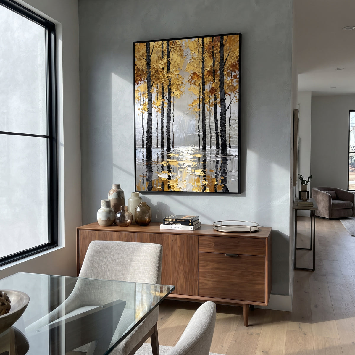 ARTWORK DETAILS Black Trunk Gold Reflection Painting is built from the actual artwork image: dark tree trunks and yellow leaves mirrored in water. The composition uses raised texture to separate tree trunks, leaf masses, ground movement, and soft background atmosphere, so the surface reads with real hand-painted depth from different viewing angles. The color direction is black, yellow, gray, chosen to keep the autumn mood warm while still leaving enough pale air and cool contrast for modern