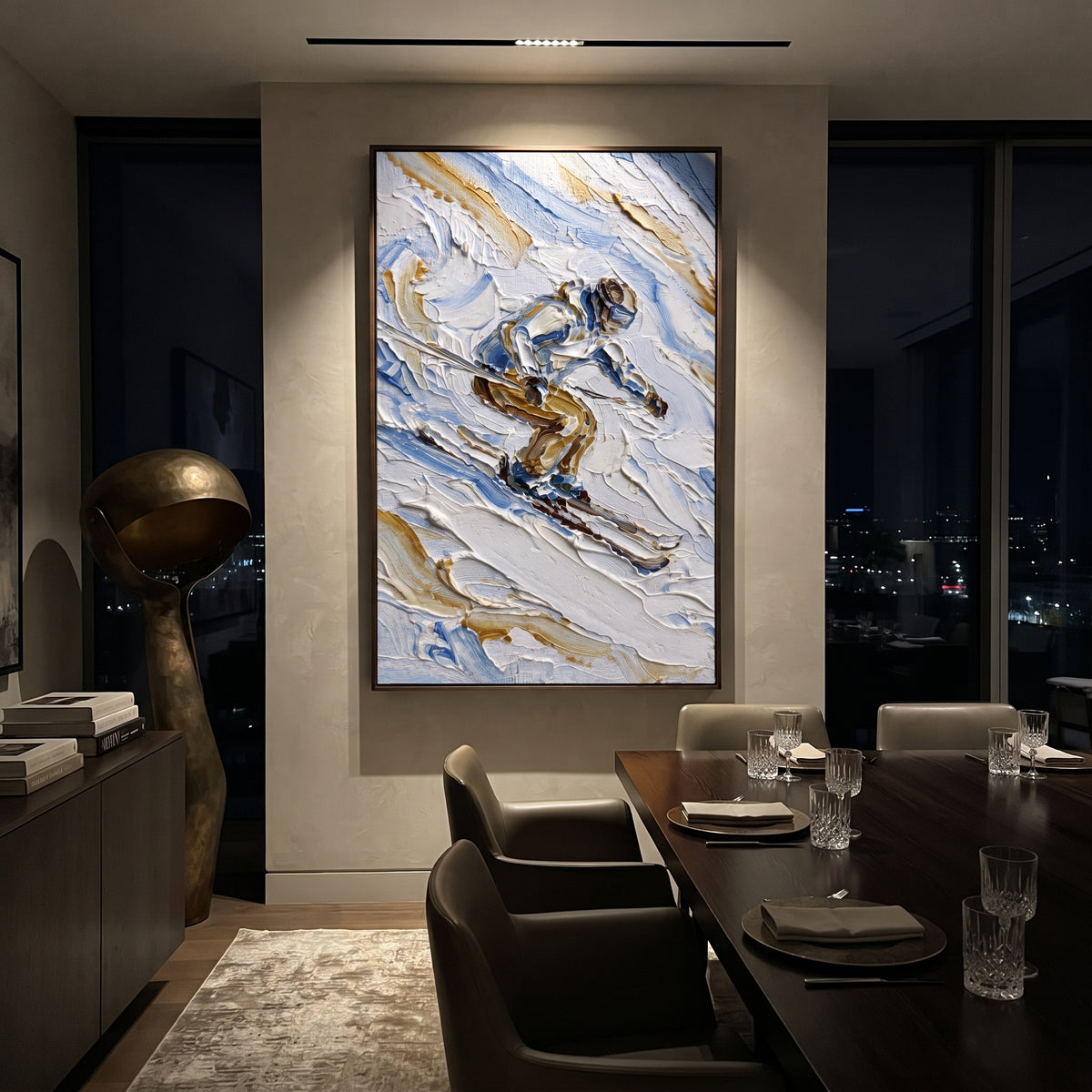 Ice Snow Trail focuses on soft gray snowfields broken by colorful skiers and thick ridge texture. The artwork shows a winter ski scene built from the actual image: visible downhill figures, curved snow tracks, raised ridgelines, and alpine space arranged in a tall composition. The blue, white, orange palette gives the piece a cold mountain atmosphere while the thick impasto surface creates shadows along each snowbank, ski line, and textured ridge. This is presented as hand-painted textured