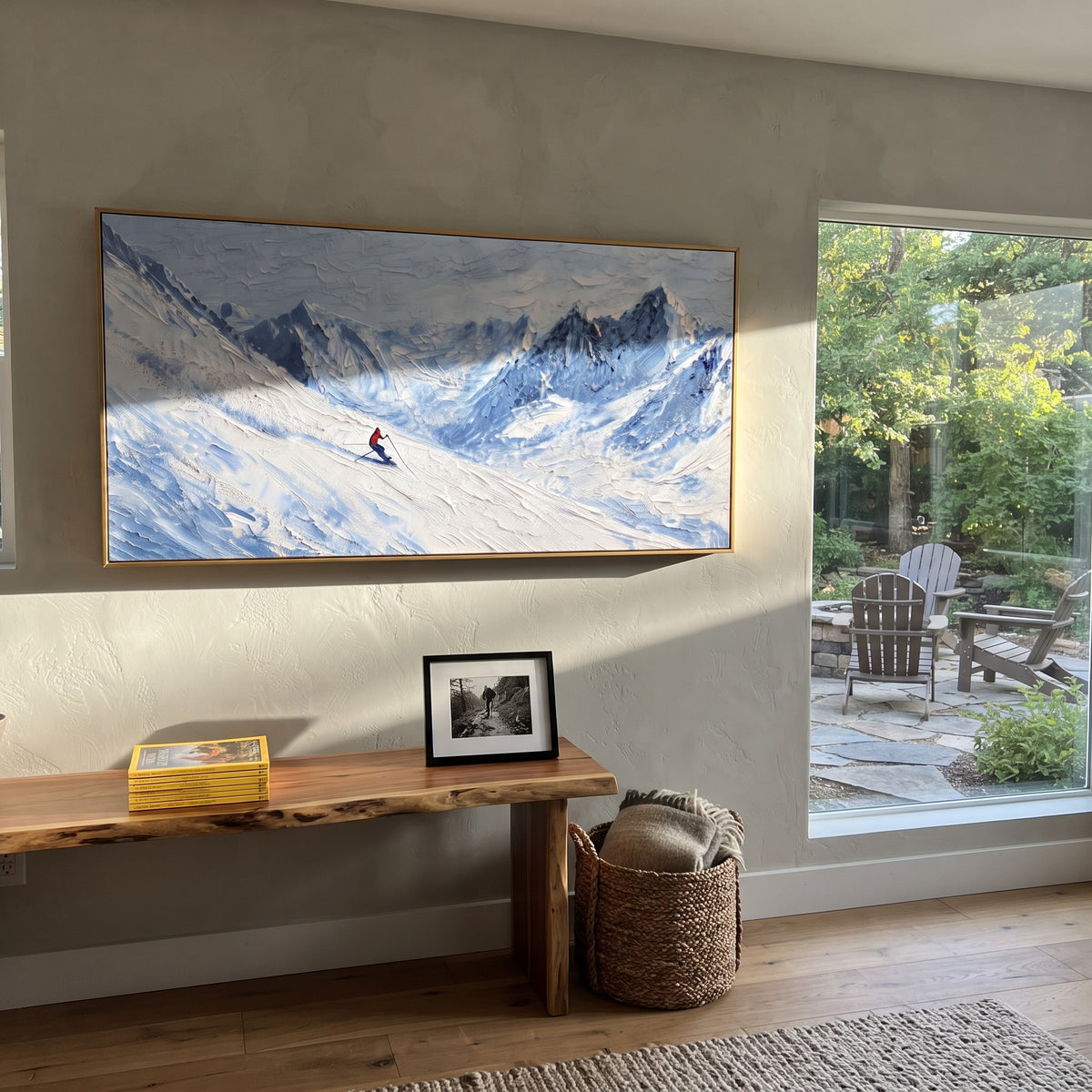 Mountain Ski Traverse focuses on small downhill figures moving over carved impasto snow channels and soft blue shadows. The artwork shows a winter ski scene built from the actual image: visible downhill figures, curved snow tracks, raised ridgelines, and alpine space arranged in a wide composition. The white, gray, blue palette gives the piece a cold mountain atmosphere while the thick impasto surface creates shadows along each snowbank, ski line, and textured ridge. This is presented as