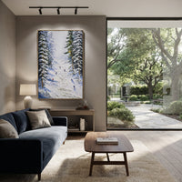Snowfield Skiers With Pine Shadows focuses on colored skiers crossing raised white snow tracks between dark pine edges. The artwork shows a winter ski scene built from the actual image: visible downhill figures, curved snow tracks, raised ridgelines, and alpine space arranged in a tall composition. The white, beige, blue palette gives the piece a cold mountain atmosphere while the thick impasto surface creates shadows along each snowbank, ski line, and textured ridge. This is presented as