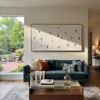 North Ski Traverse With Pine Shadows focuses on small downhill figures moving over carved impasto snow channels and soft blue shadows. The artwork shows a winter ski scene built from the actual image: visible downhill figures, curved snow tracks, raised ridgelines, and alpine space arranged in a wide composition. The blue, white, orange palette gives the piece a cold mountain atmosphere while the thick impasto surface creates shadows along each snowbank, ski line, and textured ridge. This is