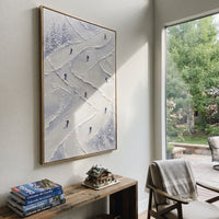 Valley Skiers focuses on colored skiers crossing raised white snow tracks between dark pine edges. The artwork shows a winter ski scene built from the actual image: visible downhill figures, curved snow tracks, raised ridgelines, and alpine space arranged in a tall composition. The white, green, blue palette gives the piece a cold mountain atmosphere while the thick impasto surface creates shadows along each snowbank, ski line, and textured ridge. This is presented as hand-painted textured