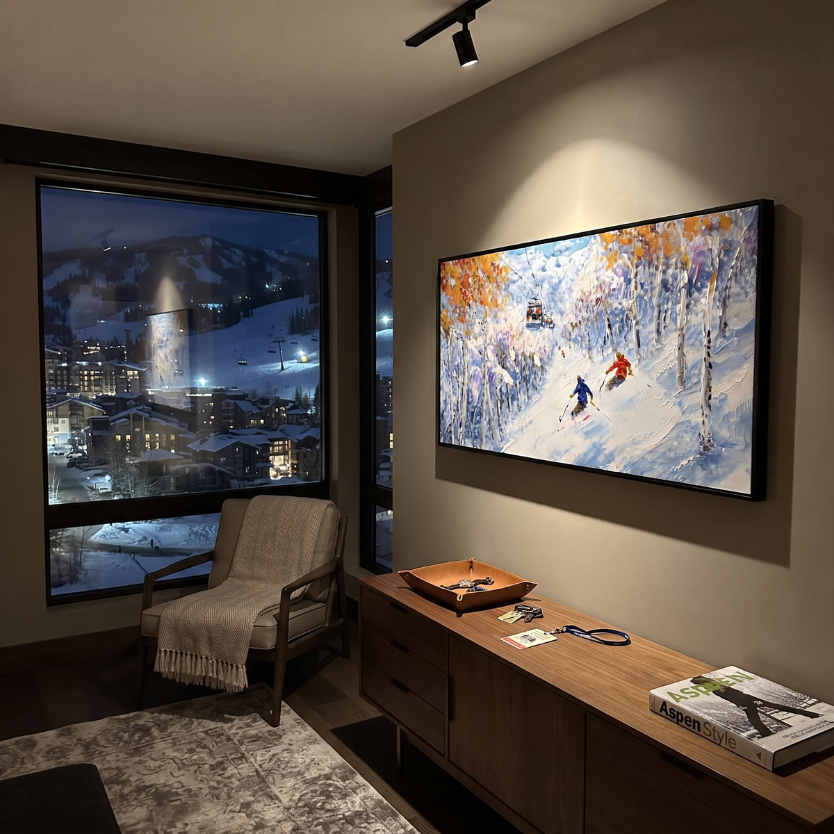 Golden Birch Ski Run focuses on two bright skiers cutting through yellowen birch trees in a snowy corridor. The artwork shows a winter ski scene built from the actual image: visible downhill figures, curved snow tracks, raised ridgelines, and alpine space arranged in a wide composition. The yellow, blue, white palette gives the piece a cold mountain atmosphere while the thick impasto surface creates shadows along each snowbank, ski line, and textured ridge. This is presented as hand-painted