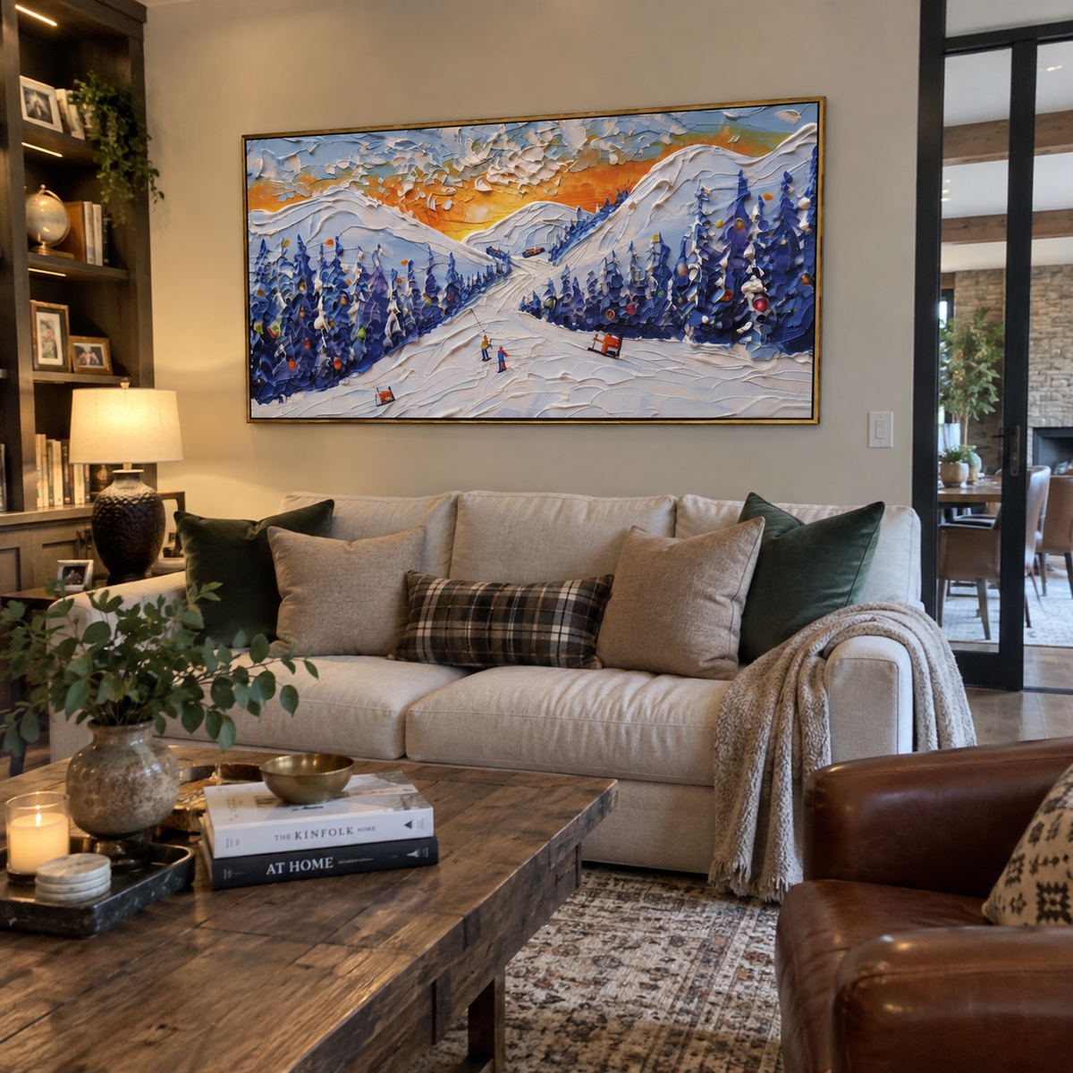 Sunset Resort Ski Road focuses on a sunset ski road between deep blue pines with warm orange sky and small red cabins. The artwork shows a winter ski scene built from the actual image: visible downhill figures, curved snow tracks, raised ridgelines, and alpine space arranged in a wide composition. The orange, blue, white palette gives the piece a cold mountain atmosphere while the thick impasto surface creates shadows along each snowbank, ski line, and textured ridge. This is presented as