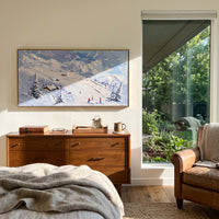 Blue Cliff Ski Lodge focuses on tiny skiers and a small lodge set beneath a raised blue cliff and snowy pines. The artwork shows a winter ski scene built from the actual image: visible downhill figures, curved snow tracks, raised ridgelines, and alpine space arranged in a wide composition. The blue, white, beige palette gives the piece a cold mountain atmosphere while the thick impasto surface creates shadows along each snowbank, ski line, and textured ridge. This is presented as hand-painted