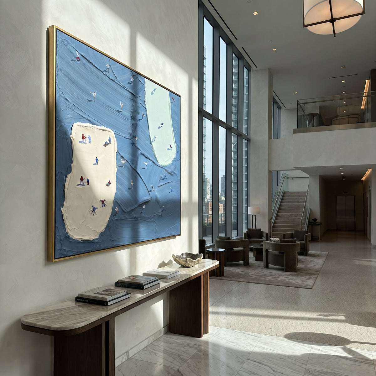 Blue Resort Island Trails focuses on tiny skiers scattered across blue resort trails divided by two pale raised ski islands. The artwork shows a winter ski scene built from the actual image: visible downhill figures, curved snow tracks, raised ridgelines, and alpine space arranged in a balanced composition. The blue, white, gray palette gives the piece a cold mountain atmosphere while the thick impasto surface creates shadows along each snowbank, ski line, and textured ridge. This is presented