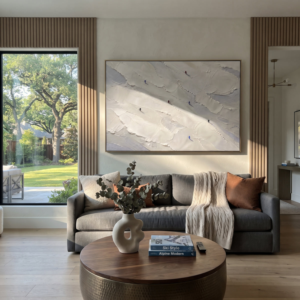 Frosted Pine Slope With Pine Shadows focuses on layered snow ridges, visible ski marks, and a quiet pine border. The artwork shows a winter ski scene built from the actual image: visible downhill figures, curved snow tracks, raised ridgelines, and alpine space arranged in a wide composition. The blue, white, orange palette gives the piece a cold mountain atmosphere while the thick impasto surface creates shadows along each snowbank, ski line, and textured ridge. This is presented as hand-painted