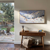 Sunlit Chalet Ski Valley focuses on a sunlit chalet valley with orange roofs, pines, white peaks, and scattered skiers. The artwork shows a winter ski scene built from the actual image: visible downhill figures, curved snow tracks, raised ridgelines, and alpine space arranged in a wide composition. The blue, orange, white palette gives the piece a cold mountain atmosphere while the thick impasto surface creates shadows along each snowbank, ski line, and textured ridge. This is presented as