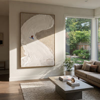 Curved Snowbank Skiers focuses on two tiny skiers tucked against a sweeping sculpted snowbank on taupe ground. The artwork shows a winter ski scene built from the actual image: visible downhill figures, curved snow tracks, raised ridgelines, and alpine space arranged in a tall composition. The white, gray, red palette gives the piece a cold mountain atmosphere while the thick impasto surface creates shadows along each snowbank, ski line, and textured ridge. This is presented as hand-painted