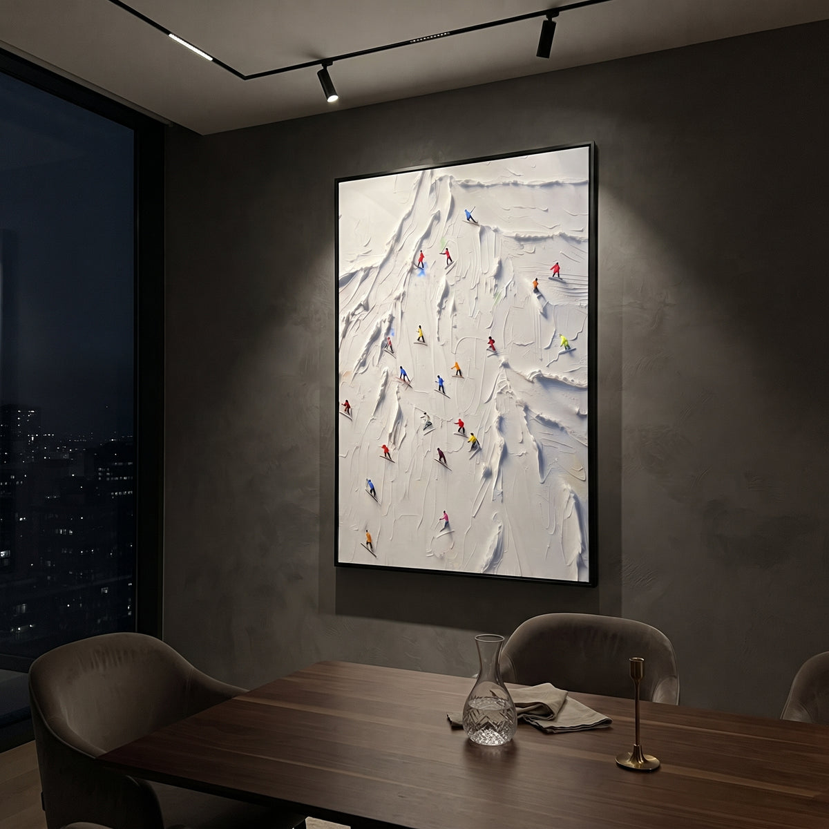 Cold Skiers focuses on tiny red, blue, and yellow skiers scattered across a sculpted alpine slope. The artwork shows a winter ski scene built from the actual image: visible downhill figures, curved snow tracks, raised ridgelines, and alpine space arranged in a tall composition. The white, beige, blue palette gives the piece a cold mountain atmosphere while the thick impasto surface creates shadows along each snowbank, ski line, and textured ridge. This is presented as hand-painted textured