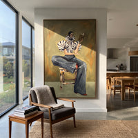 Seated Zebra Sleeve Reader focuses on the specific fashion figure shown in the artwork: seated woman in zebra striped sleeves and dark cropped trousers reading a patterned magazine. The image is built around elongated trousers, a compact upper-body pose, sculptural sleeve volume, small accessory detail, and a quiet studio background. The black, beige, green palette keeps the mood refined while the raised texture and visible brushwork make the surface feel handmade rather than printed. This