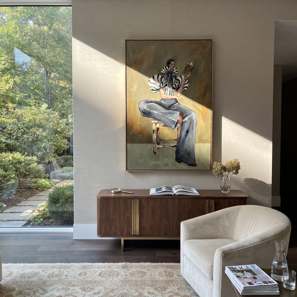 Seated Zebra Sleeve Reader focuses on the specific fashion figure shown in the artwork: seated woman in zebra striped sleeves and dark cropped trousers reading a patterned magazine. The image is built around elongated trousers, a compact upper-body pose, sculptural sleeve volume, small accessory detail, and a quiet studio background. The black, beige, green palette keeps the mood refined while the raised texture and visible brushwork make the surface feel handmade rather than printed. This