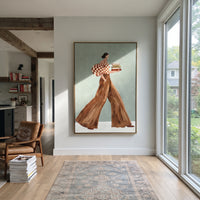 Red Check Books Walk focuses on the specific fashion figure shown in the artwork: walking woman in red check puff sleeve and brown trousers carrying stacked books. The image is built around elongated trousers, a compact upper-body pose, sculptural sleeve volume, small accessory detail, and a quiet studio background. The brown, red, green palette keeps the mood refined while the raised texture and visible brushwork make the surface feel handmade rather than printed. This made-to-order canvas