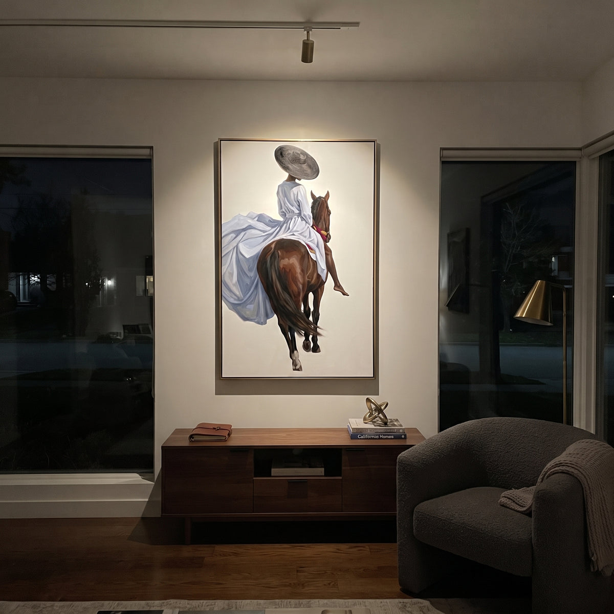 Blue Dress Back Horse focuses on blue dress back horse with pale blue dress, broad black hat, brown horse body, reins, shadows, and cream studio ground. The composition is built from the exact pose, clothing shape, accessories, furniture, animal form, shoreline, palm shape, surfboard, or table arrangement visible in this artwork, so the image reads as a specific modern figurative painting rather than a generic decorative abstract. The blue; brown; cream palette gives the piece its main